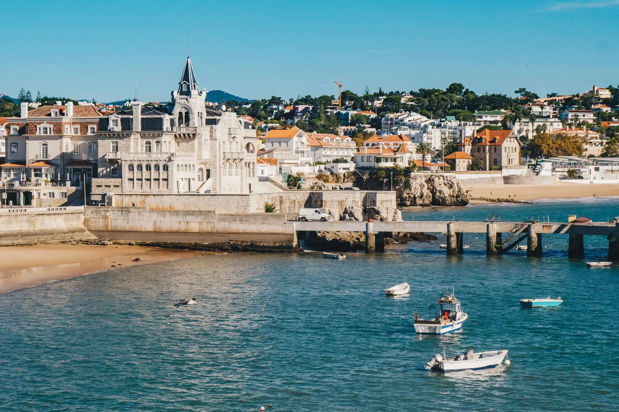 Boats in the bay below Cascais old town on a sunny day